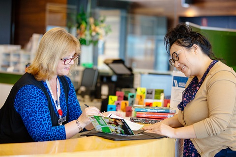 Libraries staff member signs up a new Library member