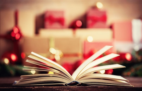 Book with open pages and christmas presents